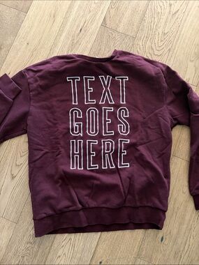 Divided Maroon Crewneck Sweatshirt with White Outline Back Text